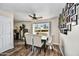 Bright dining room is decorated with hardwood floors, an elegant dining set, and decorative photo wall at 18601 N 45Th Dr, Glendale, AZ 85308