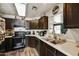 Functional kitchen featuring dark cabinetry, light countertops, and essential appliances at 18601 N 45Th Dr, Glendale, AZ 85308