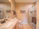 Well-lit bathroom featuring a glass-enclosed shower, light wood cabinets, and tiled floors at 19700 N 76Th St # 2091, Scottsdale, AZ 85255