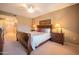 Bedroom featuring a large bed with stylish bedding, bedside tables, and carpet at 19700 N 76Th St # 2091, Scottsdale, AZ 85255