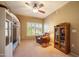 Cozy bedroom with chair, ceiling fan, and large window with plantation shutters at 19700 N 76Th St # 2091, Scottsdale, AZ 85255