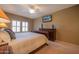 Bedroom features carpeted floor, a large bed, bedside tables and a wall-mounted television at 19700 N 76Th St # 2091, Scottsdale, AZ 85255