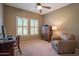 Bedroom with chair, desk, computer and built-in shutters on the windows at 19700 N 76Th St # 2091, Scottsdale, AZ 85255