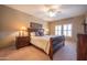 Spacious bedroom featuring carpet floors, bedside tables with lamps, and shuttered windows at 19700 N 76Th St # 2091, Scottsdale, AZ 85255