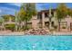 Inviting community pool with cascading waterfall feature and desert landscape backdrop at 19700 N 76Th St # 2091, Scottsdale, AZ 85255