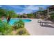 Community pool surrounded by desert landscaping, lounge chairs, and nearby residential buildings at 19700 N 76Th St # 2091, Scottsdale, AZ 85255
