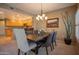 Dining room with a modern chandelier, comfortable seating, and open to kitchen at 19700 N 76Th St # 2091, Scottsdale, AZ 85255