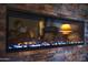 Modern fireplace with a stone surround and an electric flame display at 19700 N 76Th St # 2091, Scottsdale, AZ 85255