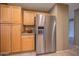 Bright kitchen featuring a stainless steel KitchenAid refrigerator and light wood cabinetry at 19700 N 76Th St # 2091, Scottsdale, AZ 85255
