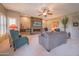Inviting living room with a stone fireplace, mounted TV, and comfortable armchairs at 19700 N 76Th St # 2091, Scottsdale, AZ 85255