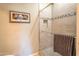 Bathroom shower showcasing tiled walls with decorative accents and a glass door at 19700 N 76Th St # 2091, Scottsdale, AZ 85255