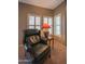 Cozy corner area featuring plantation shutters and a comfortable armchair at 19700 N 76Th St # 2091, Scottsdale, AZ 85255
