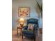 Relaxing corner with comfortable armchair, side table, and a decorative painting at 19700 N 76Th St # 2091, Scottsdale, AZ 85255