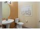 Charming powder room featuring pedestal sink and beach-themed wall art at 20017 N Cielo Ct, Surprise, AZ 85374
