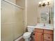 Cozy bathroom featuring a toilet, sink with vanity, and shower with glass door at 20017 N Cielo Ct, Surprise, AZ 85374