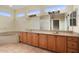 Primary bathroom with double sinks, soaking tub, and natural light at 20017 N Cielo Ct, Surprise, AZ 85374