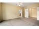 Large primary bedroom with carpet flooring and access to the en-suite bathroom and walk-in closet at 20017 N Cielo Ct, Surprise, AZ 85374