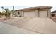Wide driveway leading up to a beige home with a tile roof and multi-car garage at 20017 N Cielo Ct, Surprise, AZ 85374