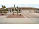 Desert landscaping accents this home featuring a tile roof and three-car garage at 20017 N Cielo Ct, Surprise, AZ 85374