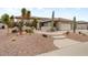 Inviting desert landscaping and concrete pathway to the front door of this beige home at 20017 N Cielo Ct, Surprise, AZ 85374