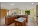 Kitchen features a center island, tile flooring, granite countertops, and breakfast bar at 20017 N Cielo Ct, Surprise, AZ 85374