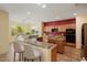 Kitchen with granite counters, tile floors, stainless appliances, and an island with seating at 20017 N Cielo Ct, Surprise, AZ 85374