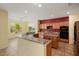 Kitchen area with granite counters, tile floors, stainless appliances, breakfast bar, and island at 20017 N Cielo Ct, Surprise, AZ 85374