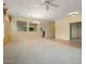 Expansive living room with neutral carpet, ceiling fan, and partial view of other rooms at 20017 N Cielo Ct, Surprise, AZ 85374