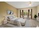 This staged bedroom has a large window and sitting area, bringing in natural light at 20017 N Cielo Ct, Surprise, AZ 85374