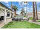 Beautiful backyard featuring artificial grass, a pool with seating, an outdoor kitchen area, and desert landscaping at 2026 S Emerson --, Mesa, AZ 85210