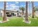 Spacious backyard with artificial grass, a pool, palm trees, outdoor dining, and lounge area for entertaining at 2026 S Emerson --, Mesa, AZ 85210