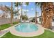 Expansive backyard featuring a pool, patio furniture, lush green grass, and mature palm trees for shade at 2026 S Emerson --, Mesa, AZ 85210