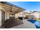 Backyard view features a covered patio with lounge area, a pool, and low maintenance landscaping at 2218 W Curry St, Chandler, AZ 85224