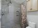 Updated bathroom features tiled shower with built-in niche, updated tile floor, and neutral vanity cabinet at 2218 W Curry St, Chandler, AZ 85224
