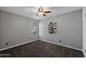 Bedroom features a ceiling fan and window that provides natural light and neutral paint and carpet at 2218 W Curry St, Chandler, AZ 85224