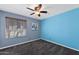 Light filled bedroom features a ceiling fan, neutral carpeting, and bright accent wall and window at 2218 W Curry St, Chandler, AZ 85224