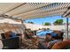 Inviting covered patio with comfortable seating and a view of the sparkling pool and waterfall feature at 2218 W Curry St, Chandler, AZ 85224