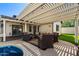 Relaxing covered patio area with ample seating, a decorative rug, and string lights above at 2218 W Curry St, Chandler, AZ 85224