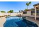 Sparkling swimming pool with easy access, rock features, and mature trees to enhance privacy at 2218 W Curry St, Chandler, AZ 85224