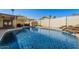 Inviting swimming pool with sparkling blue water, a rock waterfall feature, and low block fencing at 2218 W Curry St, Chandler, AZ 85224