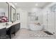 Bright bathroom featuring a freestanding tub, glass shower, and dual vanities at 23060 E Sonoqui Blvd, Queen Creek, AZ 85142