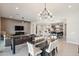 Open-concept space with dining table and chairs, foosball table, and view into the kitchen at 23060 E Sonoqui Blvd, Queen Creek, AZ 85142