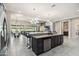 Large kitchen island with seating, dark wood cabinets, and granite countertops, blending style with functionality at 23060 E Sonoqui Blvd, Queen Creek, AZ 85142
