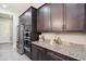 Well-equipped kitchen with dark wood cabinets, granite countertops, and stainless steel appliances for modern cooking convenience at 23060 E Sonoqui Blvd, Queen Creek, AZ 85142