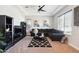 Cozy living room with tray ceiling, neutral carpet, a modern ceiling fan, and stylish decor creating a relaxing atmosphere at 23060 E Sonoqui Blvd, Queen Creek, AZ 85142