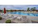 Community pool with lounge seating, umbrellas, and manicured landscaping at 23060 E Sonoqui Blvd, Queen Creek, AZ 85142