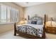 Bedroom with decorative metal bedframe, neutral walls, and shuttered window at 23520 N 80Th Way, Scottsdale, AZ 85255