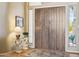 Elegant entryway featuring a wooden double door, decorative table, and neutral decor at 23520 N 80Th Way, Scottsdale, AZ 85255