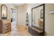 Hallway with stone flooring, furnishings, mirrors, and access to other rooms at 23520 N 80Th Way, Scottsdale, AZ 85255