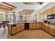 Open kitchen with coffered ceiling, tile floors, and stainless steel appliances at 23520 N 80Th Way, Scottsdale, AZ 85255